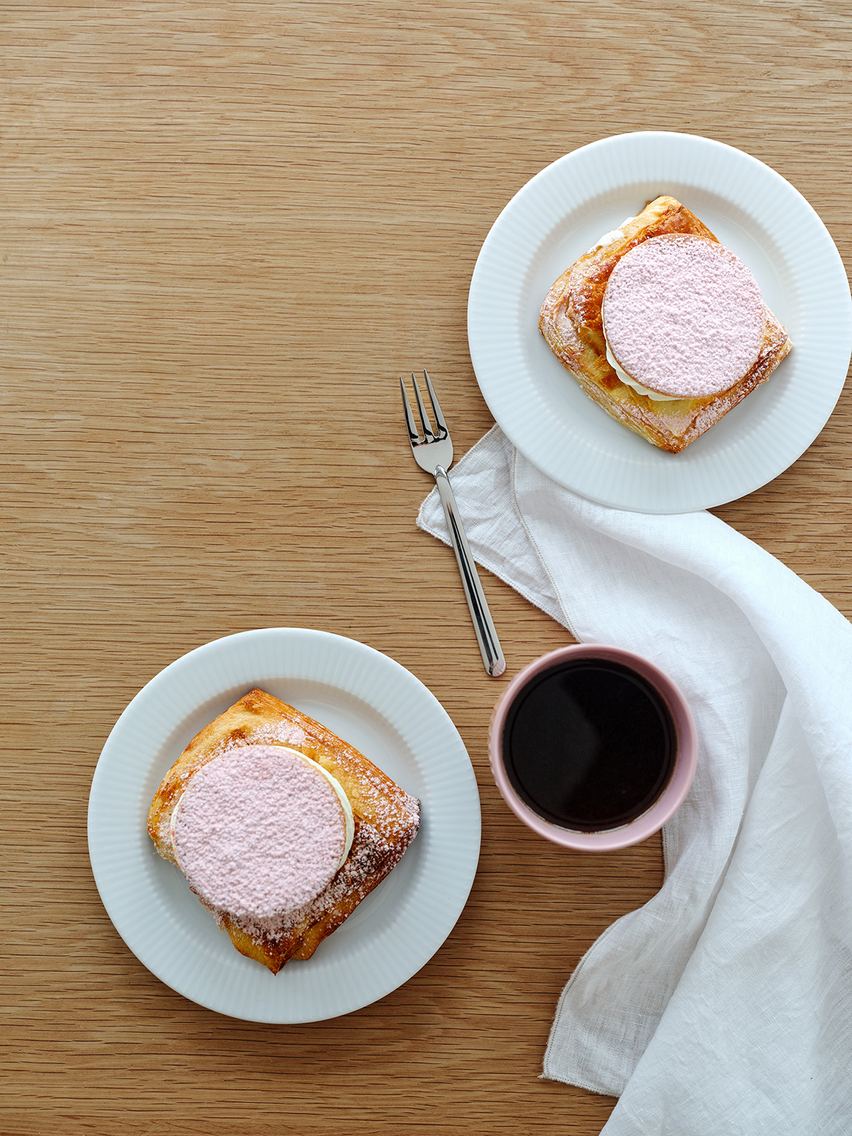 Ein gedeckter Kaffeetisch mit zwei Legio Nova Frühstückstellern und Kuchengebäck.